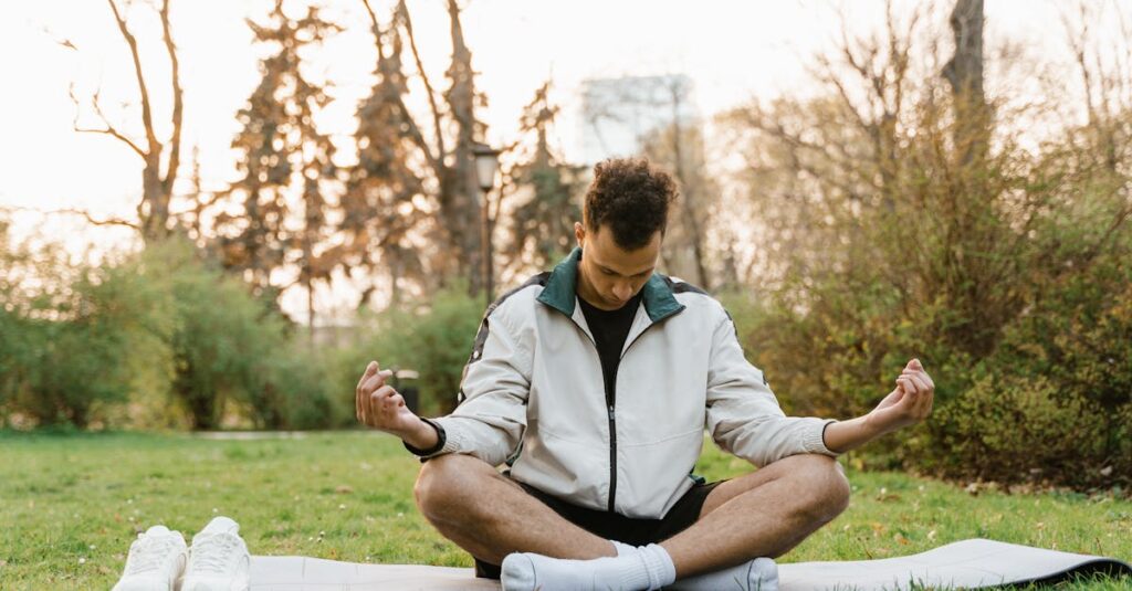 A man practices meditation in a serene park, embodying relaxation and mindfulness.